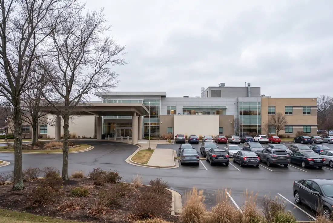 Wide exterior of a hospital building with a driveway on an overcast day in Chicago