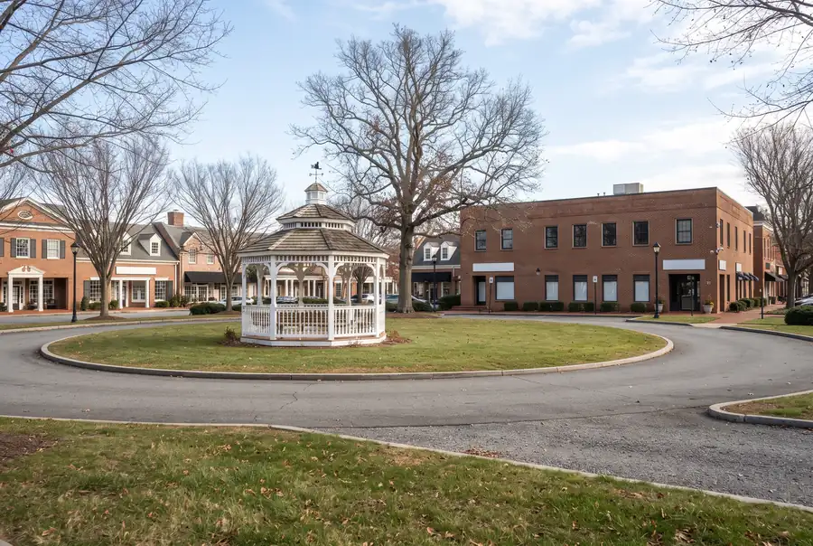 Village green with a gazebo and brick storefronts in Elmwood Park, Illinois
